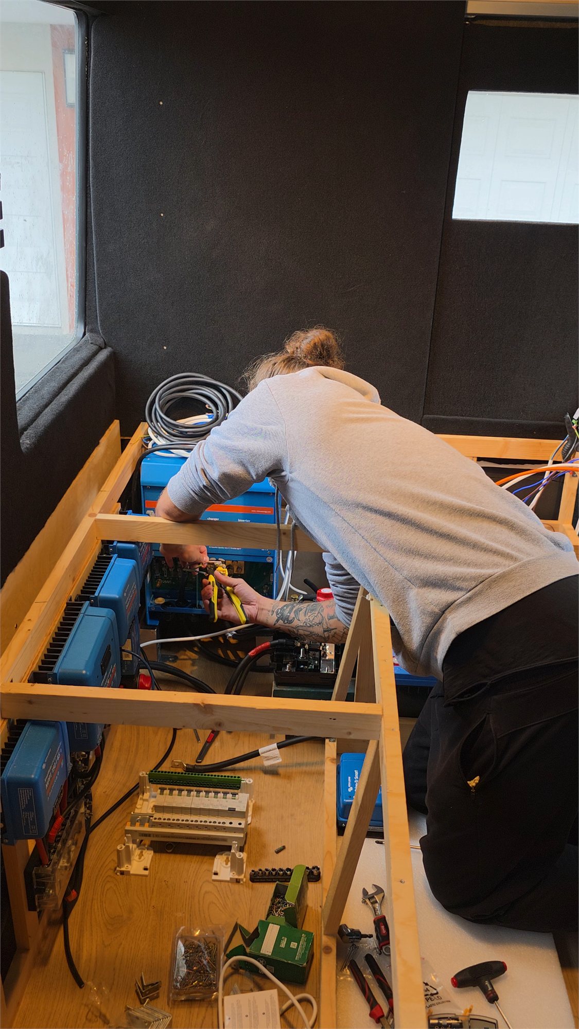 Gaël travaille sur le circuit électrique d’un van client